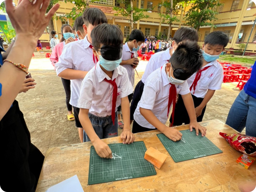 Two boys playing during eye care festival in Khan Hoa Primary School in Vietnam